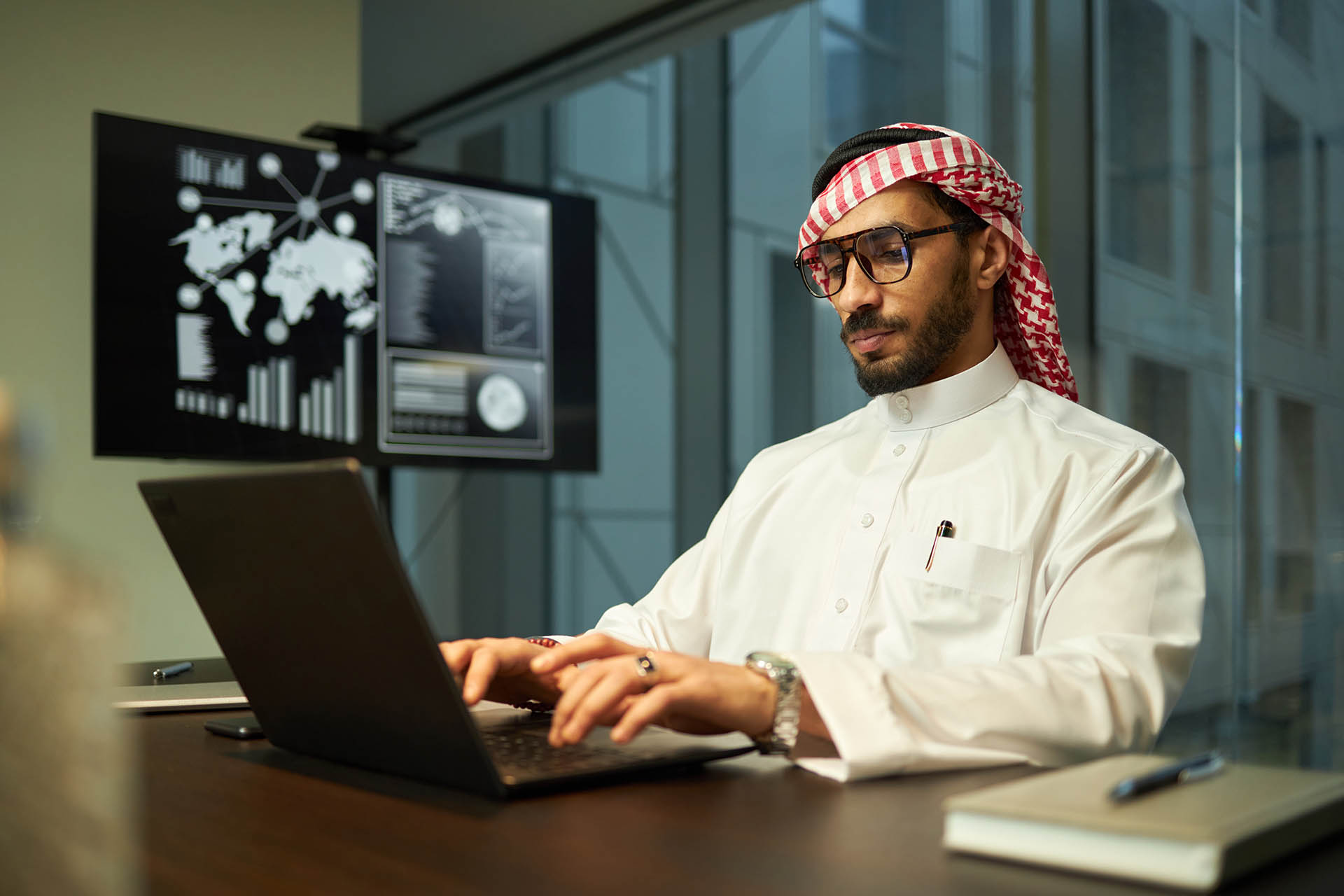 Middle Eastern Businessman Focused on Work in Office